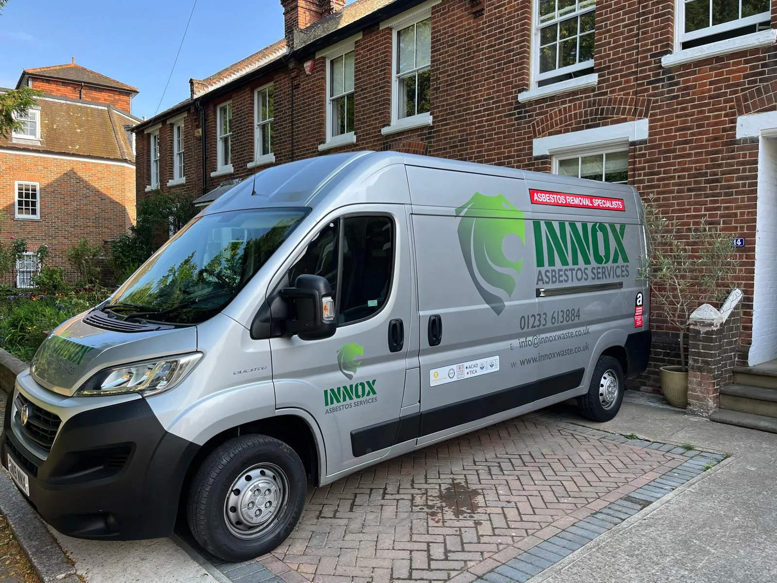 INNOX asbestos services van outside a residential property